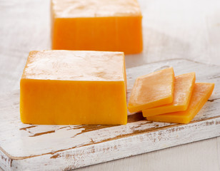 Cheddar Cheese on  wooden Cutting Board. © bit24