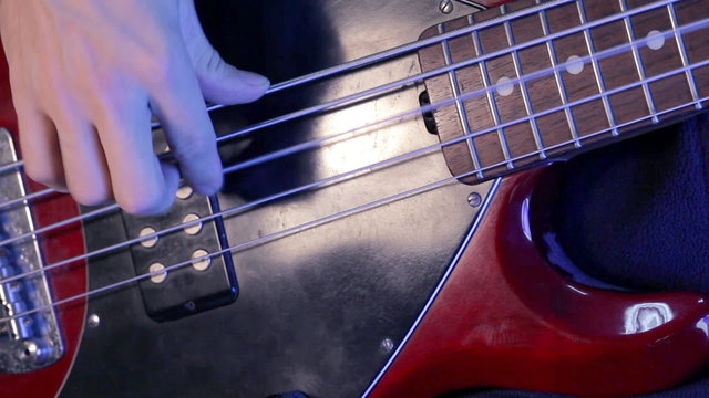 Musician practicing electric bass guitar