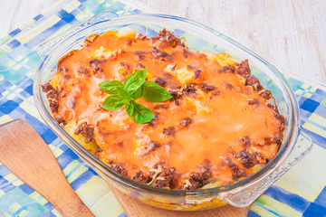 Potato gratin with cream, cheese and tomatoes