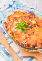 Potato gratin with cream, cheese and tomatoes