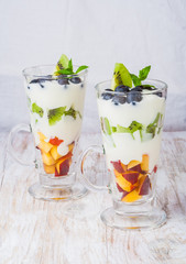 Fresh fruit in cream. Dessert from fruit and cream