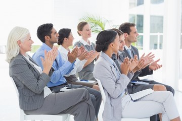 Business people applauding during meeting 