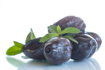 dried plums with a sprig of mint