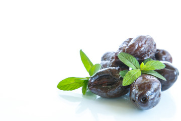 dried plums with a sprig of mint