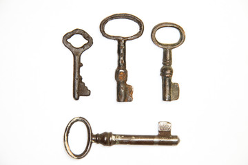 A lot vintage keys from the locks on a white background