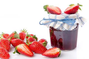 Fresh strawberries and strawberry jam jar