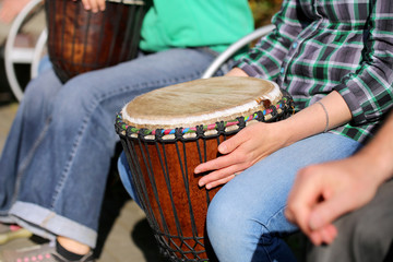 woman playing on Africa Jambe Drum