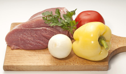 Raw fresh meat on board with condiments on white background