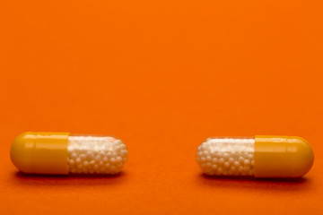 Yellow medical capsules with text space