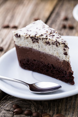 Chocolate dessert with coffee cup and coffee beans on wooden bac