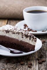 Chocolate dessert with coffee cup and coffee beans on wooden bac