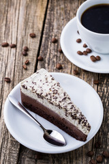 Chocolate dessert with coffee cup and coffee beans on wooden bac