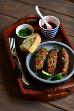 kebabs with berry sauce and cilantro in a vintage tray 