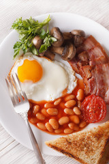 English breakfast close-up on a plate. vertical top view
