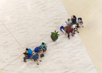 High angle view of people resting on benches...