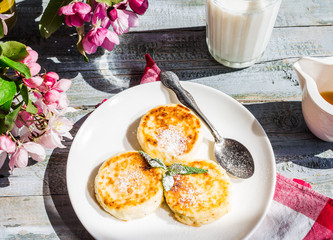 cheese pancakes with mint and powdered sugar, flowers, healthy b