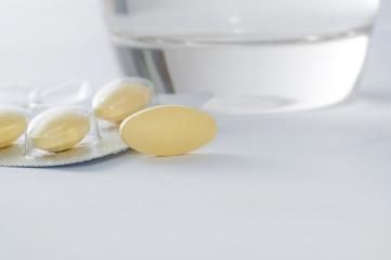 Glass of water and pills