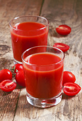 Fresh tomato juice and tomatoes on the table, selective focus