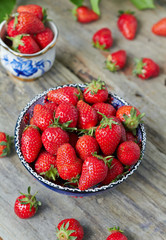 Fresh juicy strawberry in a blue bowl