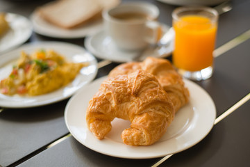 Croissant Breakfast served with black coffee and breakfast menu.