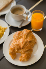 Croissant Breakfast served with black coffee and breakfast menu.