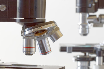 Two black vintage microscopes, side view