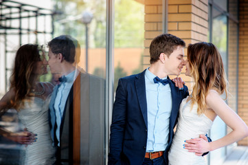 happy bride and groom walking in a city