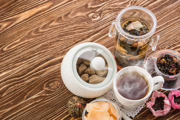 Tea cups with teapot on old wooden table