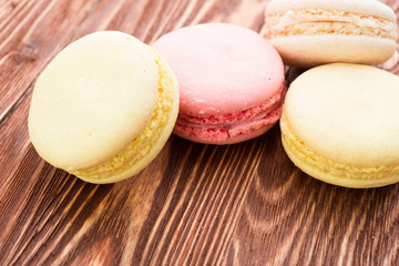 A lot of french colorful cookies on wooden