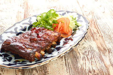 Meat on a grill with vegetables