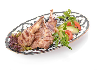 Meat on a grill with vegetables
