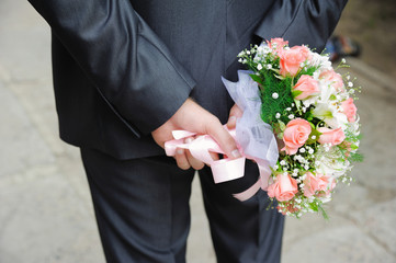 groom with wedding flowers