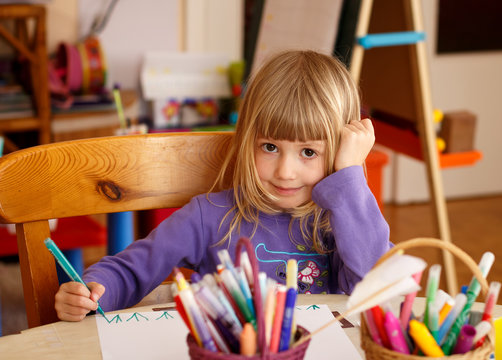 Young girl drawing in pre-school
