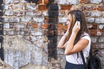 Girl  listening to music in headphones.