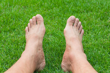 Barefoot Legs on the Green Grass in Garden