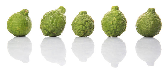 Kaffir or makrut lime over white background