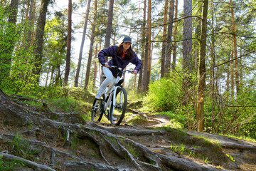 Bike riding - woman on bike in forest