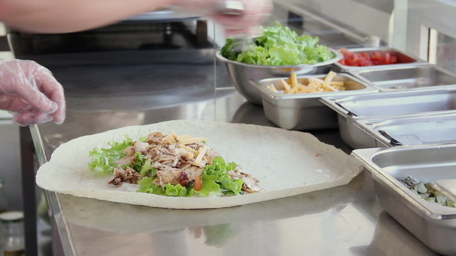 A Food Stall Seller Packing Shawarma 