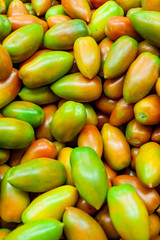 Fresh raw red and green tomatoes in market