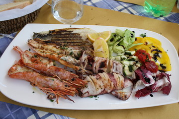 Assorted seafood grilled and served on salad