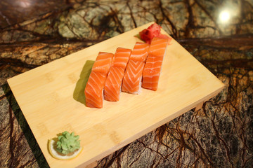 Delicious Sapporo maki sushi rolls served with a wood plate.