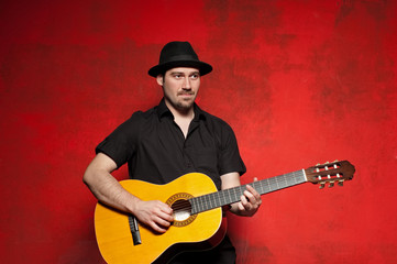 Young man playing guitar with joy