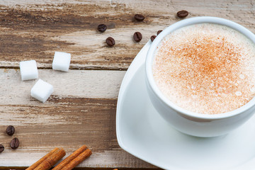 Sugar cubes, coffee cup, coffee beans and cinnamon