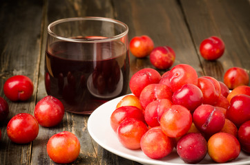Fresh plum (Julee) and juice on wooden background