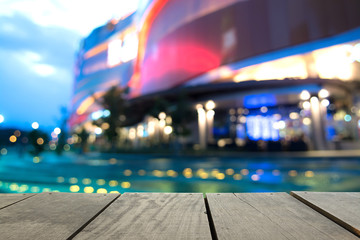 Blur image of terrace wood and swimming pool in modern hotel