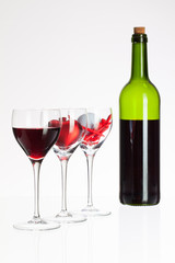 Wine glasses with red wine, heart and golf ball