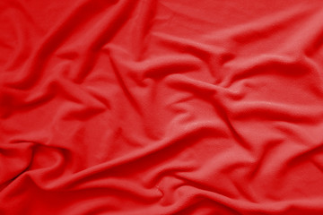 Creased red cloth material fragment as a background