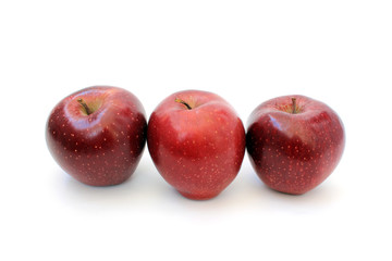 Three apples standing in a row