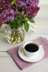 cup with coffee and lilac