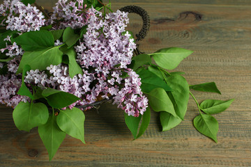 The beautiful lilac on a wooden background